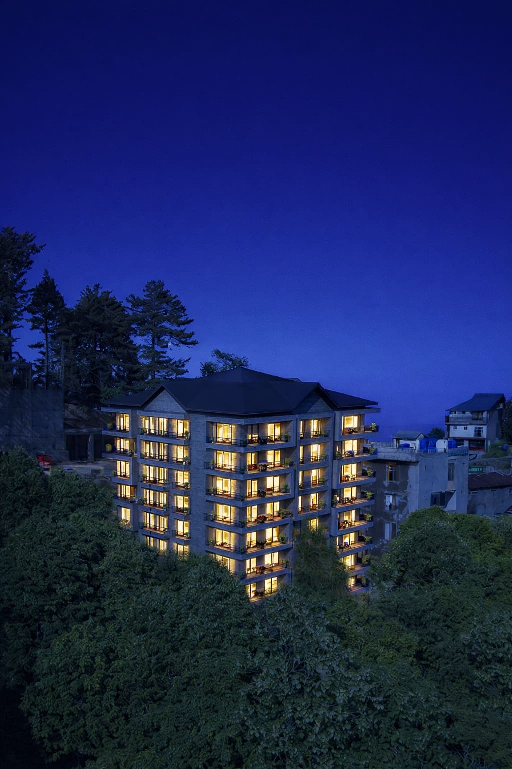 Skyline Terrace at dusk, its windows glowing against a deep blue sky
